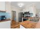 Modern kitchen boasts stainless appliances, ample countertop space, and stylish tiled backsplash at 5022 Belleglen Ct. # 202, Myrtle Beach, SC 29579