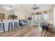 Bright, open living area with wood floors, vaulted ceiling, and access to a screened porch at 5022 Belleglen Ct. # 202, Myrtle Beach, SC 29579