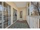 View of screened porch featuring sliding glass doors, exterior door and decorative area rug at 5022 Belleglen Ct. # 202, Myrtle Beach, SC 29579