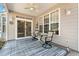 Covered back porch with ceiling fan, seating, area rug and view of backyard at 542 Sand Ridge Rd., Conway, SC 29526