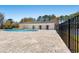Community pool with brick pavers, black metal fence and large building in background at 542 Sand Ridge Rd., Conway, SC 29526