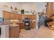 Kitchen with light wood cabinets, stainless steel appliances and decor on wall shelf at 542 Sand Ridge Rd., Conway, SC 29526
