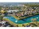 Aerial view of community featuring homes with mature trees, manicured lawns, water features, and landscaping at 7268 Seville Dr., Myrtle Beach, SC 29572