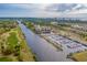 Aerial view of a marina featuring boat slips, a waterway, and residential buildings with water views at 7268 Seville Dr., Myrtle Beach, SC 29572