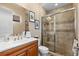Bathroom featuring a wood vanity with white marble top and a glass enclosed shower at 7268 Seville Dr., Myrtle Beach, SC 29572