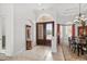 Grand foyer with a tiled floor and high ceilings, featuring a decorative mirror and access to the dining room at 7268 Seville Dr., Myrtle Beach, SC 29572