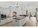 Modern kitchen with white cabinets, granite countertops, stainless steel appliances, and a large center island at 7268 Seville Dr., Myrtle Beach, SC 29572