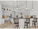 Modern kitchen featuring white cabinetry, granite countertops, stainless steel appliances, and a breakfast bar at 7268 Seville Dr., Myrtle Beach, SC 29572