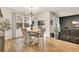 Bright dining room with wood floors, large windows, and a modern chandelier at 1016 Laurens Mill Dr., Myrtle Beach, SC 29579