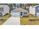 Inviting single-story home featuring a two-car garage and well-manicured lawn at 1016 Laurens Mill Dr., Myrtle Beach, SC 29579