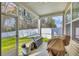 Cozy screened porch features outdoor furniture and tranquil views of the backyard at 1016 Laurens Mill Dr., Myrtle Beach, SC 29579
