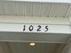 Close up of the house number '1025' on a white exterior wall at 1025 Jase Dr., Longs, SC 29568
