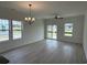 Sun-filled living room featuring neutral walls and light wood floors at 1025 Jase Dr., Longs, SC 29568
