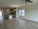 Open living room with hardwood floors connecting to the kitchen area at 1025 Jase Dr., Longs, SC 29568