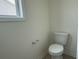 Small powder room with a white toilet and window at 1025 Jase Dr., Longs, SC 29568