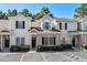 Charming townhome featuring a brick facade, neutral siding, black shutters and a well-maintained landscaped front yard at 111 Maddux Ln. # B, Myrtle Beach, SC 29588