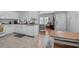 Well-lit kitchen featuring white cabinets, subway tile backsplash, and modern appliances, flowing into the living area at 111 Maddux Ln. # B, Myrtle Beach, SC 29588