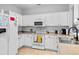 This bright kitchen features white cabinets, a microwave, and tile floors creating a clean and efficient cooking space at 111 Maddux Ln. # B, Myrtle Beach, SC 29588