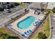 Aerial view of the community pool, featuring lounge chairs, a covered picnic area, and well maintained landscaping at 111 Maddux Ln. # B, Myrtle Beach, SC 29588