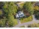 Aerial view of a blue home surrounded by lush trees and green lawn at 160 Shipmaster Ave., Pawleys Island, SC 29585
