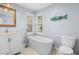 Bathroom featuring freestanding tub under window with blinds and a decorative wall hanging at 160 Shipmaster Ave., Pawleys Island, SC 29585