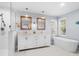 Bright bathroom featuring double vanity, freestanding tub, and glass enclosed shower at 160 Shipmaster Ave., Pawleys Island, SC 29585