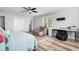 Bright bedroom with wood floors, ceiling fan, chair, and desk by the window at 160 Shipmaster Ave., Pawleys Island, SC 29585