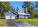 Beautiful blue home with a two-car garage, well-maintained lawn, and a welcoming front porch at 160 Shipmaster Ave., Pawleys Island, SC 29585