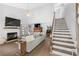 Spacious living room featuring hardwood floors, fireplace, staircase, and comfortable seating area at 160 Shipmaster Ave., Pawleys Island, SC 29585