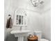 Powder room with pedestal sink, ornate mirror, and toilet at 160 Shipmaster Ave., Pawleys Island, SC 29585