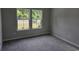 Bedroom showcasing natural light with two windows and neutral carpeting at 1848 Seachase Way, North Myrtle Beach, SC 29582