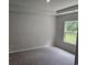 Neutral bedroom with plush carpet, a tray ceiling, and a large window at 1848 Seachase Way, North Myrtle Beach, SC 29582