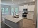 Modern kitchen with stainless steel appliances, a center island, and bright white cabinets at 1848 Seachase Way, North Myrtle Beach, SC 29582