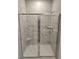 Modern bathroom shower featuring marble-patterned tiles and glass doors at 1848 Seachase Way, North Myrtle Beach, SC 29582