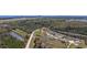 Wide aerial shot showcases a home with a treelined backdrop, accented by a picturesque pond, and distant city views at 206 Math Place, Longs, SC 29568