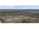 Expansive aerial view of a home surrounded by lush trees with a glimpse of the distant ocean and city skyline at 206 Math Place, Longs, SC 29568