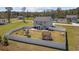 Spacious fenced backyard features a playset, trampoline, patio, and lush green grass perfect for outdoor activities at 206 Math Place, Longs, SC 29568