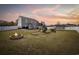 A large backyard features a playset, trampoline, and an outdoor fire pit for entertaining guests at 206 Math Place, Longs, SC 29568