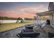 Inviting backyard patio with comfortable seating, a modern fire pit, and a view of the backyard's playset at 206 Math Place, Longs, SC 29568