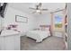 Charming bedroom features a ceiling fan, neutral palette, and bright pink accents at 206 Math Place, Longs, SC 29568