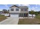 Charming two-story home with a well-manicured lawn, brick accents, and a cozy front porch at 206 Math Place, Longs, SC 29568