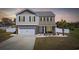 Charming two-story home with a well-manicured lawn, brick accents, and a cozy front porch at 206 Math Place, Longs, SC 29568