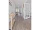 Inviting hallway with wood flooring, light gray walls, and view to dining area at 206 Math Place, Longs, SC 29568