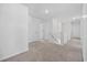 Upstairs hallway features neutral carpet, white walls and trim, and three doors to other rooms in the home at 206 Math Place, Longs, SC 29568