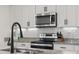Close-up of the kitchen with granite countertops, stainless steel appliances, and a stylish faucet at 206 Math Place, Longs, SC 29568