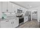 Bright kitchen featuring white cabinets, granite countertops, and stainless steel appliances at 206 Math Place, Longs, SC 29568