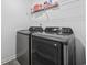 Laundry room featuring modern washer and dryer appliances with a wire shelf above them for storage at 206 Math Place, Longs, SC 29568