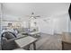 Spacious living room with ceiling fan, plush sectional sofa, and stylish decor at 206 Math Place, Longs, SC 29568