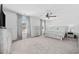 Light, airy main bedroom boasts a ceiling fan, and large windows with decorative curtains at 206 Math Place, Longs, SC 29568