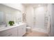 Bright bathroom featuring double vanity, white cabinetry, and a spacious walk-in shower at 247 Warner Crossing Way, Loris, SC 29569